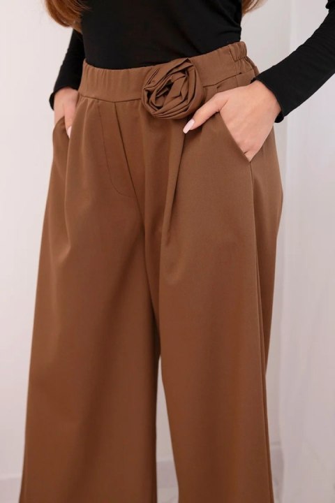 Spodnie damskie eleganckie z szeroką nogawką i ozdobnym kwiatem jasno brązowe